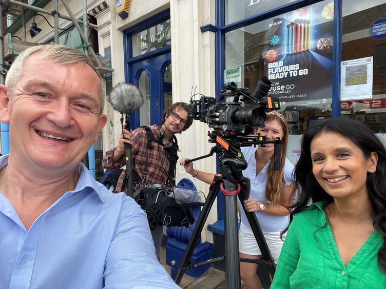 Editor Alan Quick, left, and presenter Sonali Shah, right, with the camera crew in Crediton High Street.