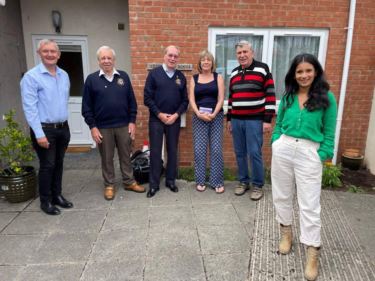 Alan Quick, left, with members of Crediton Lions Club with Sonali Shah, right.