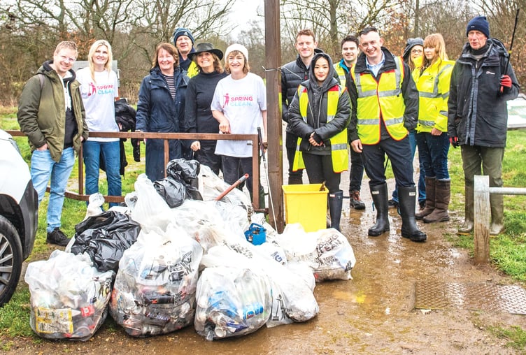 Philippa Anderson is pictured, top left centre, with litter pickers and some of the bags of rubbish collected.