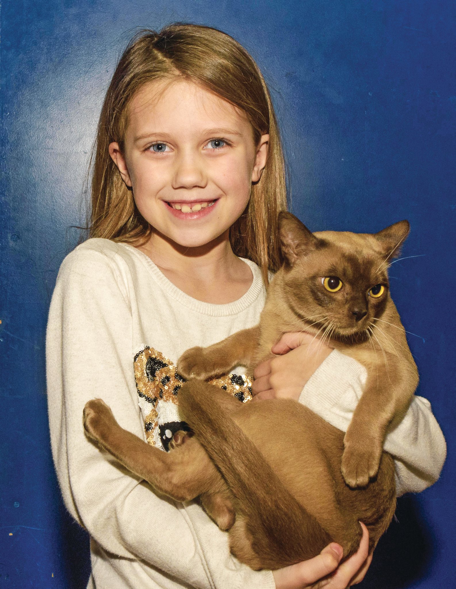 Six-year-old Ellie with her Burmese cat Loki, a multi-medal winner.