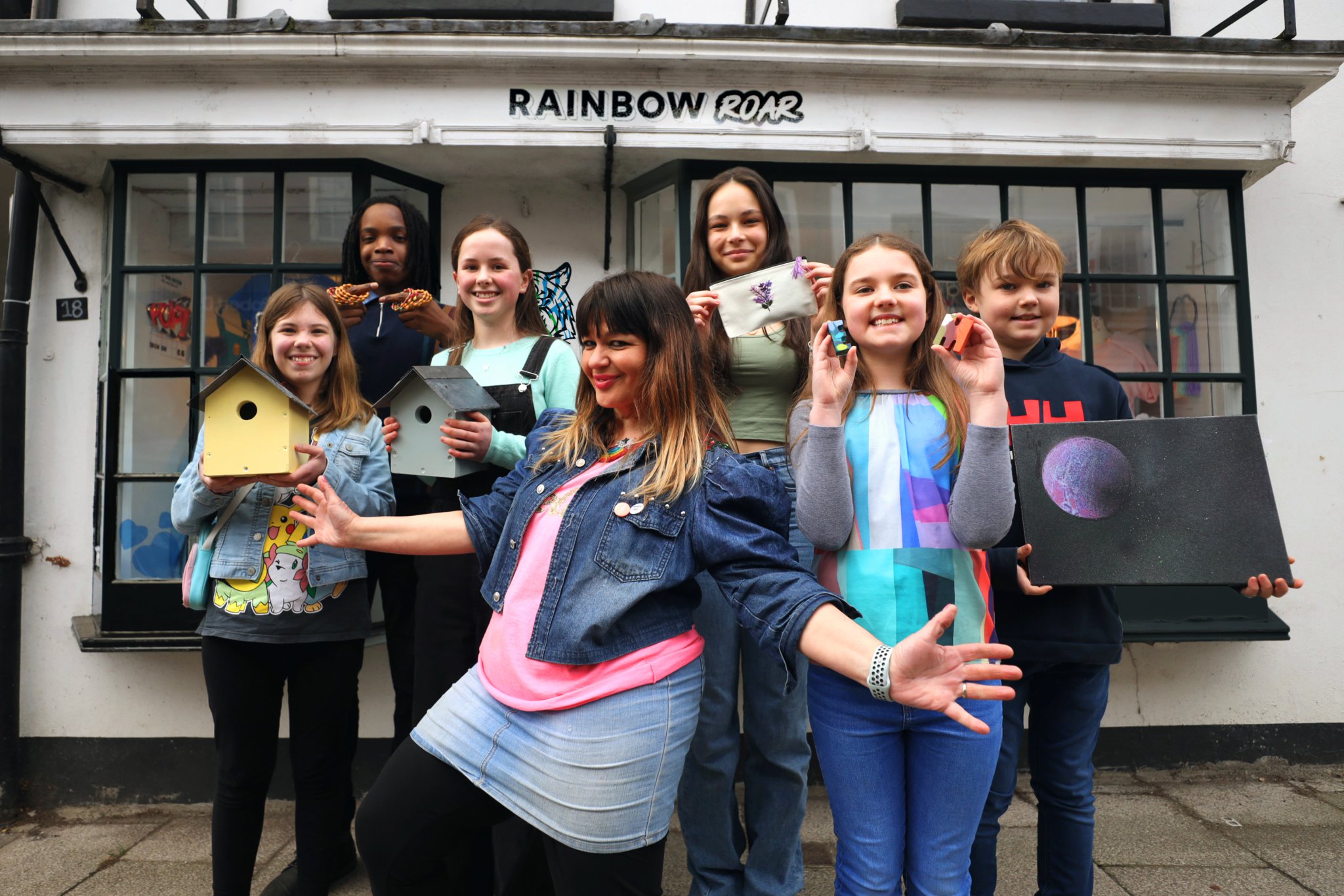 <p>Anna Londei with her Rainbow Roar crew in Downing Street, Farnham</p>