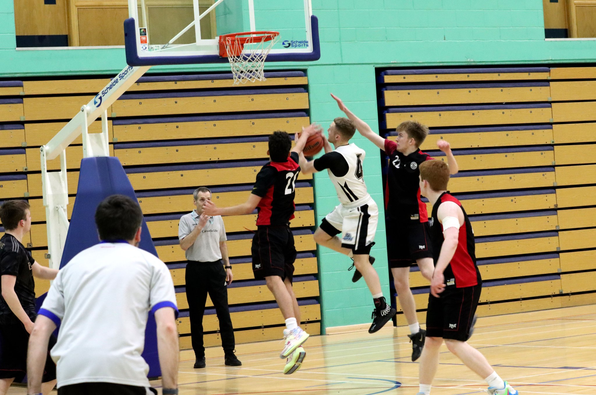 Tom Dalton-Brown drives tothe basket and attempts a lay-up for Jets under pressure from several Ravens opponents during their Isle of Man Basketball Association Senior League clash at the NSC last Thursday evening. Dalton-Brown helped Jets win 72-37 (Photo: Kyle Furlong)