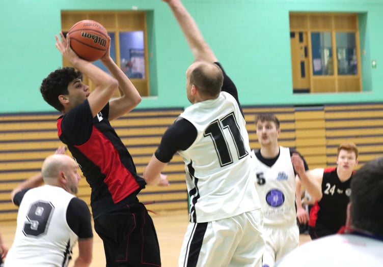 Miltos Provatakis shoots for Ravens as Jets’ Wayne Mears jumps in to attempt the block during the two sides’ Senior League clash at the National Sports Centre on Thursday evening (Photo: Kyle Furlong)