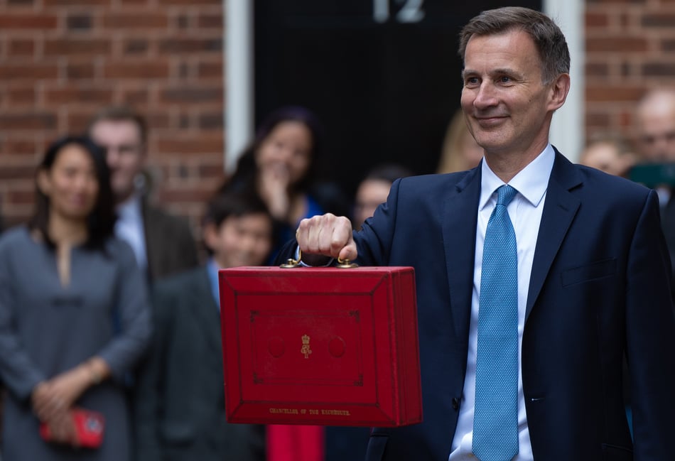 <p>The Chancellor of the Exchequer Jeremy Hunt, accompanied by his ministerial team and watched by his wife and children, leaves 11 Downing Street on his way to deliver the budget</p>