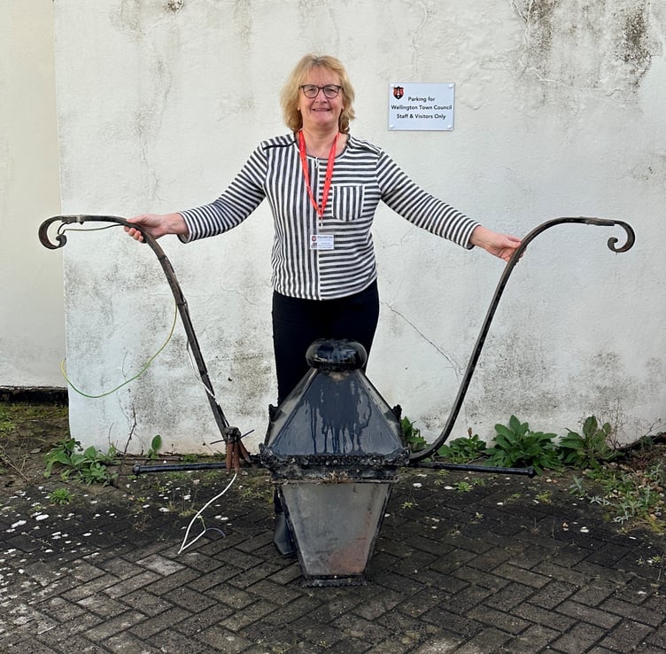 Wellington Town Council's Annette Kirk shows off a Victorian lantern which councillors want to restore and re-hang in Cornhill.