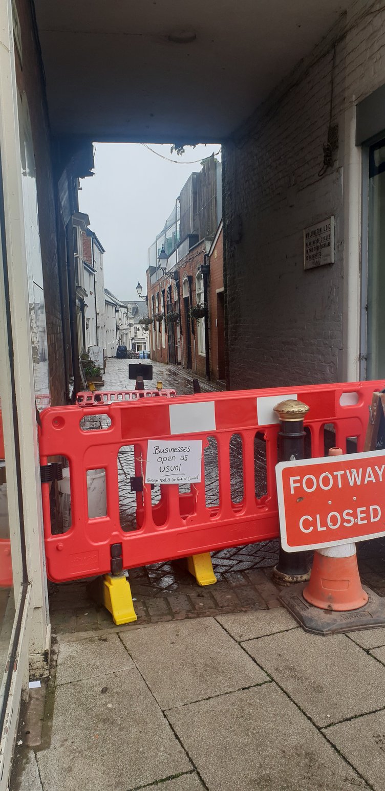 Business open as usual sign at the Fore Street end of the Cornhill closure in Wellington.