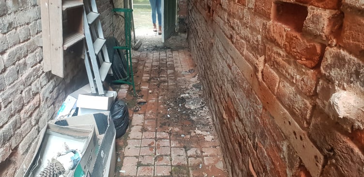 Debris which has fallen onto a private alleyway next to shops in Cornhill, Wellington.