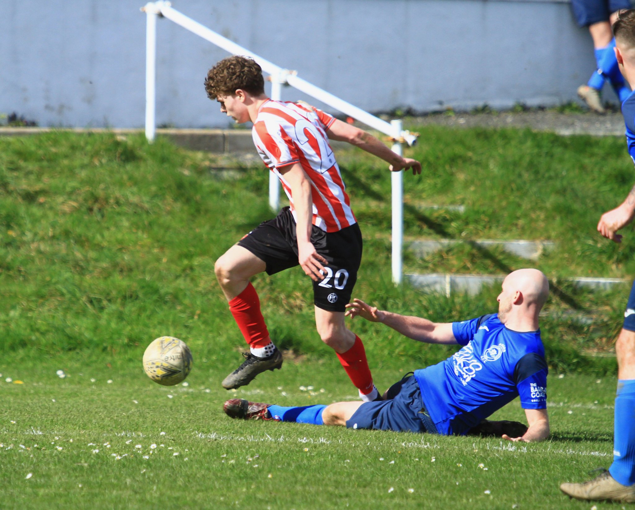Peel’s Freddie O’Donaghue skips past the challenge of DHSOB’s Karl Gartland at Blackberry Lane. The western youngster will be hoping to help his side beat Corinthians in this Saturday’s FA Cup final (Photo: Dave Norton)