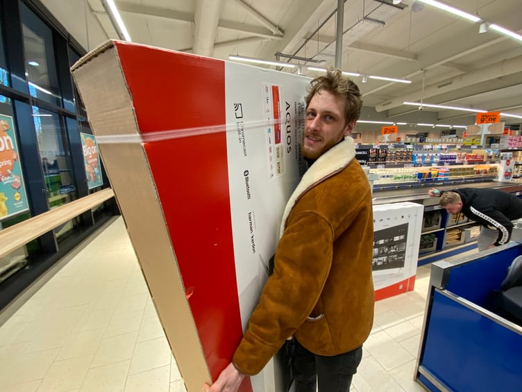 Hemyock resident Huw Walker was the new store's first customer, grabbing a 65 inch TV for his mother