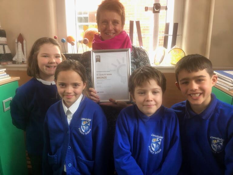 Camelsdale School RE subject leader Lindsay Russell and pupils with the school’s new certificate