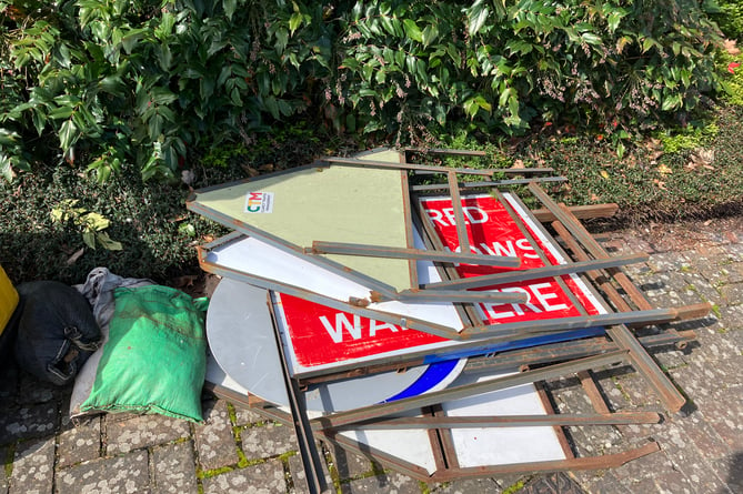 Road signs laying by the side of West Street in Farnham