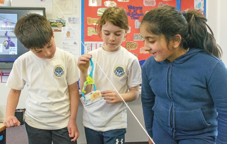 Joseph, Annabel and Zahira constructing a zip wire.