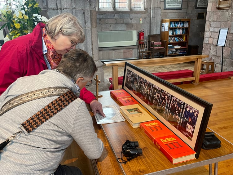 German visitors looking at details about St Boniface. AQ 6454