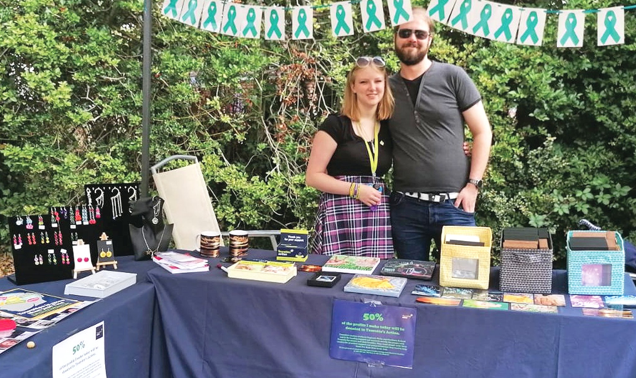 ON SALE – Lauren Wyatt and her partner, Jack Mumford, at a stall with her art and jewellry.