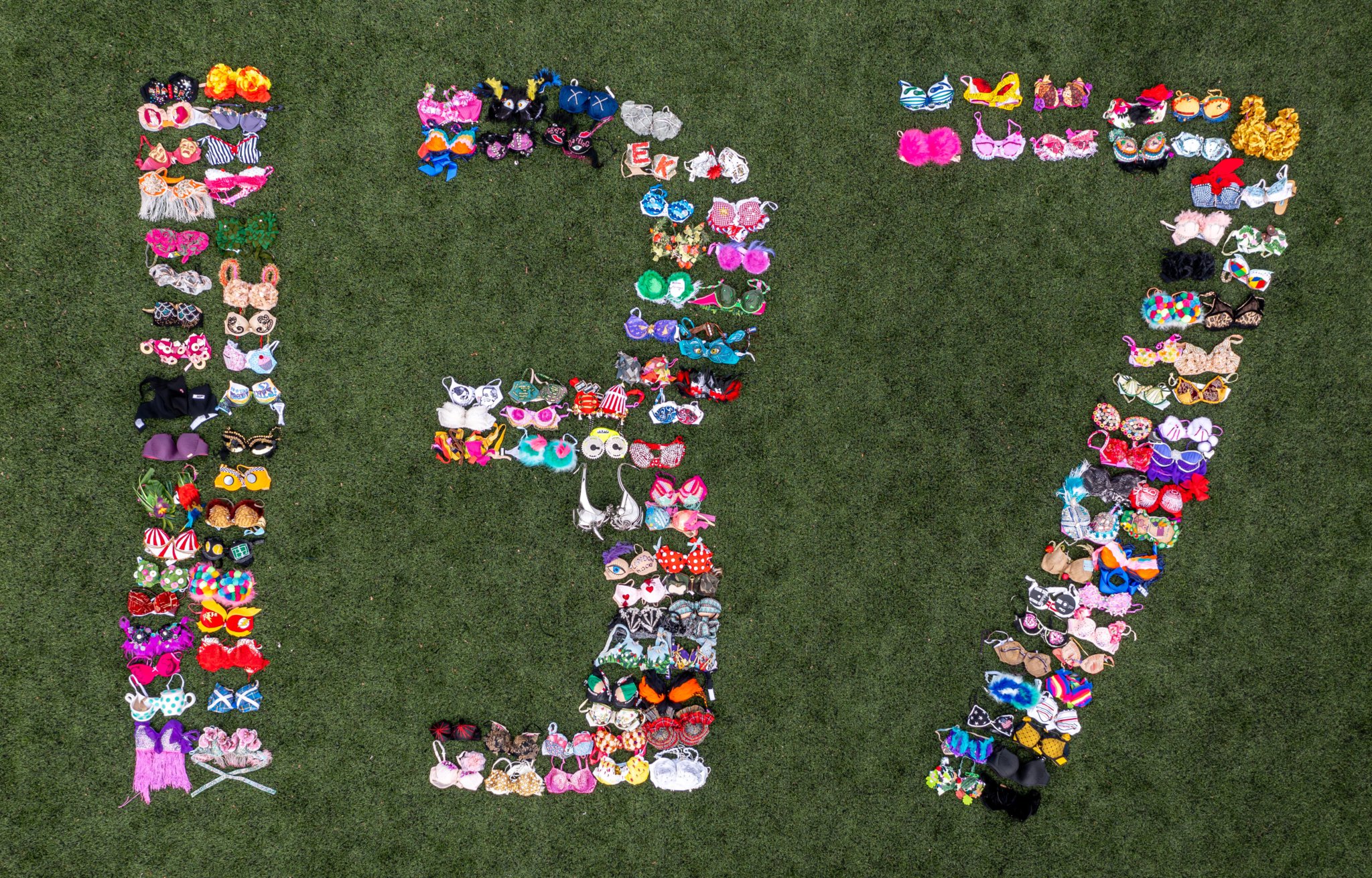 SUPPORT – Walk the Walk staff member Rachael Hopson arranges 137 brightly decorated bras to celebrate the breast cancer charity raising £137m.