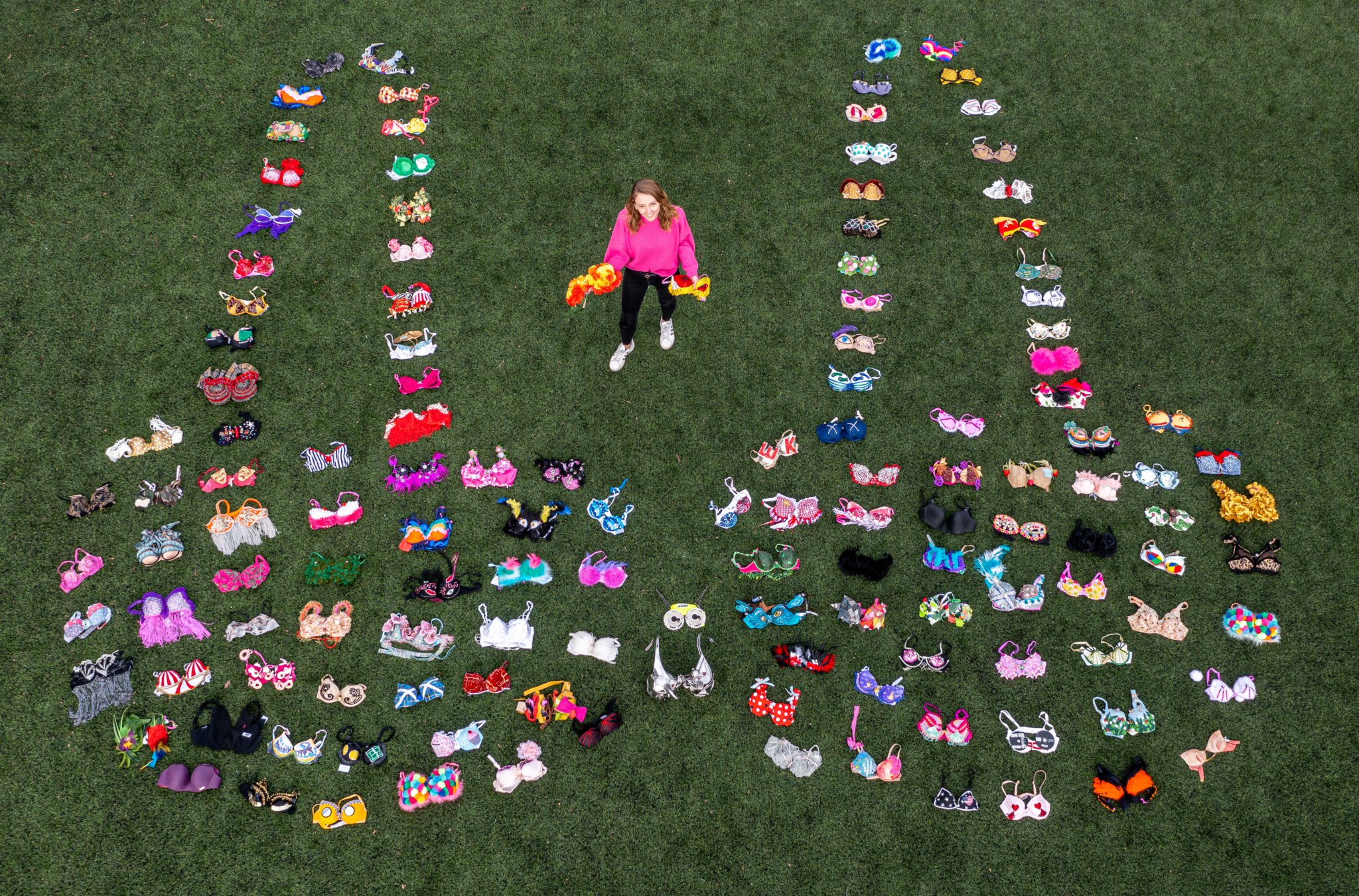 SUPPORT – Walk the Walk staff member Rachael Hopson arranges 137 brightly decorated bras to celebrate the breast cancer charity raising £137m.