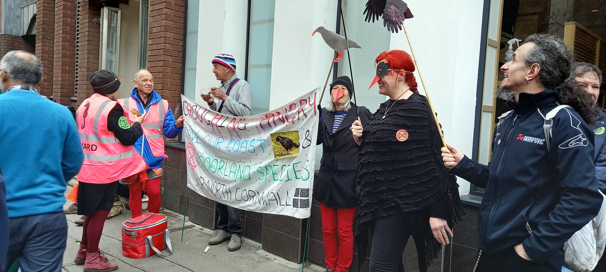 North Cornwall area residents with their flag outside DEFRA — from left (in steward hi-vis) Helen Wood, Jonathan Holt, Haydn Wood, Lucy Dove, Claire Eldridge and Roland