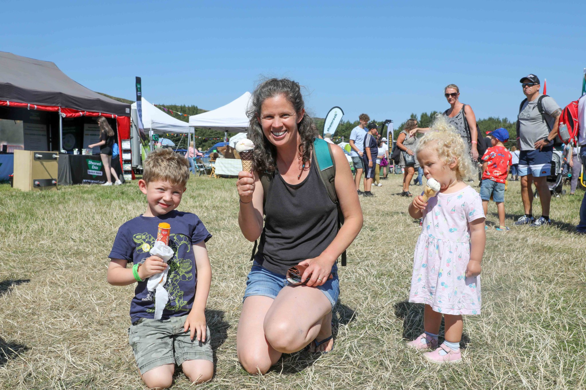 Ewan Jackson, Steph Jackson & Aoife Jackson having an ice cream at Royal Manx Agricultural Show 2022. Photo by Callum Staley (CJS Photography)