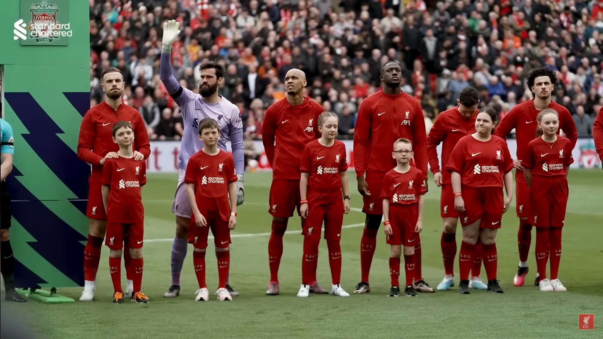 Esme (far right) standing with the Liverpool squad beore the 2-2 draw with Arsenal