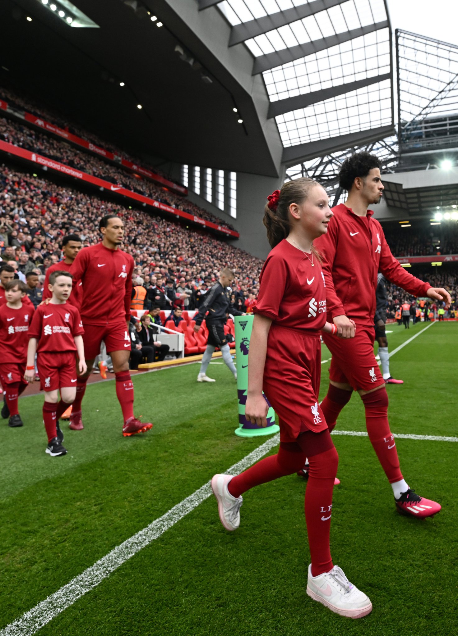 Esme Faragher walks out on the hallowed turf of Anfield with Liverpool's Curtis Jones before the game