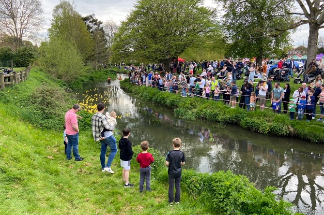 Crowds line both banks of the River Wey at Gostrey Meadow for the 35th Great Farnham Duck Race