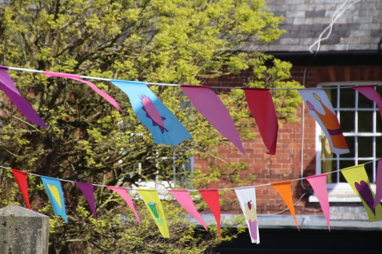Flags in Crediton Town Square by Alan Quick