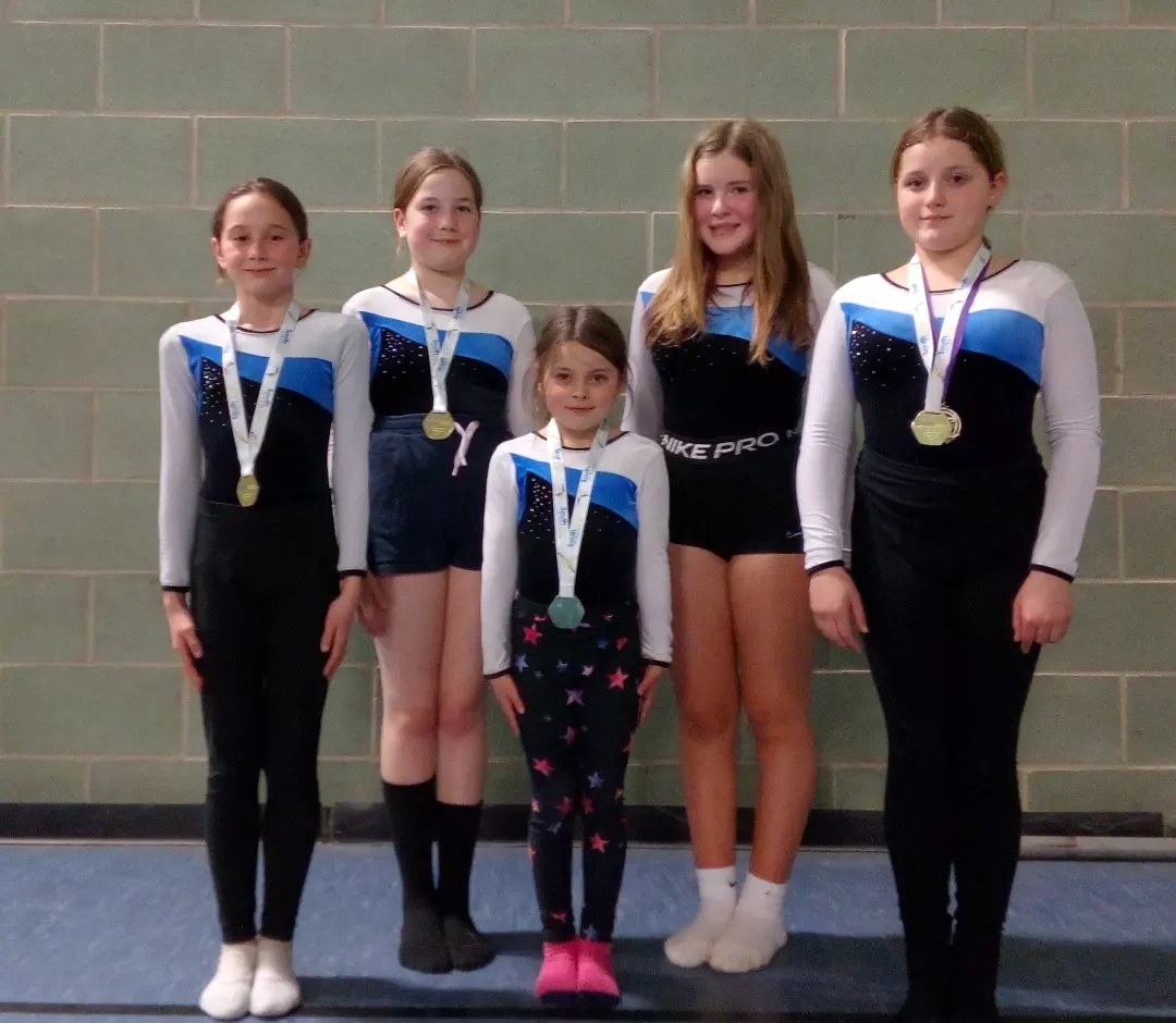 ABOVE: The Okehampton Flyers team and coaches in Bath. RIGHT: Olivia Laverty, Paige Raines, Molly Thorn, Sienna Bryant, Chloe Bifani.