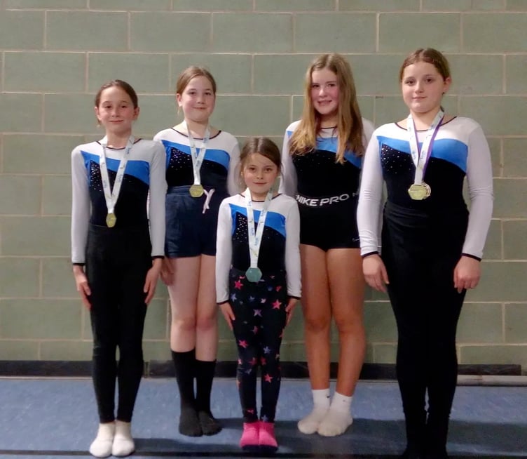 ABOVE: The Okehampton Flyers team and coaches in Bath. RIGHT: Olivia Laverty, Paige Raines, Molly Thorn, Sienna Bryant, Chloe Bifani.