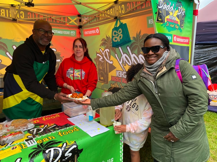 Caribbean Food was one of the many delicacies on offer at the King Charles III Coronation Weekend on The Den. Here Drew, Lisa and Nemiah serve Dionne Overfield-Nemiah. Picture Nick Knight (7-5-23)