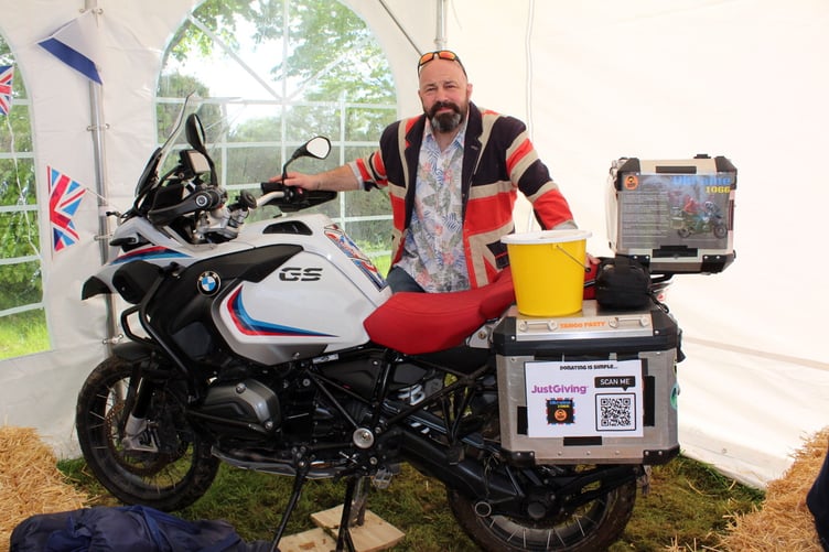 John Wilton with the bike he is riding to Ukraine. SR 7612