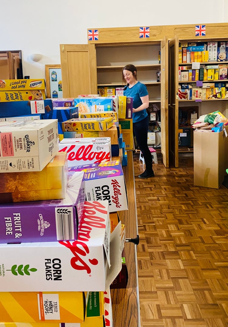 Cally Elston cleaning the cereal mountain for West Somerset Food Cupboard.