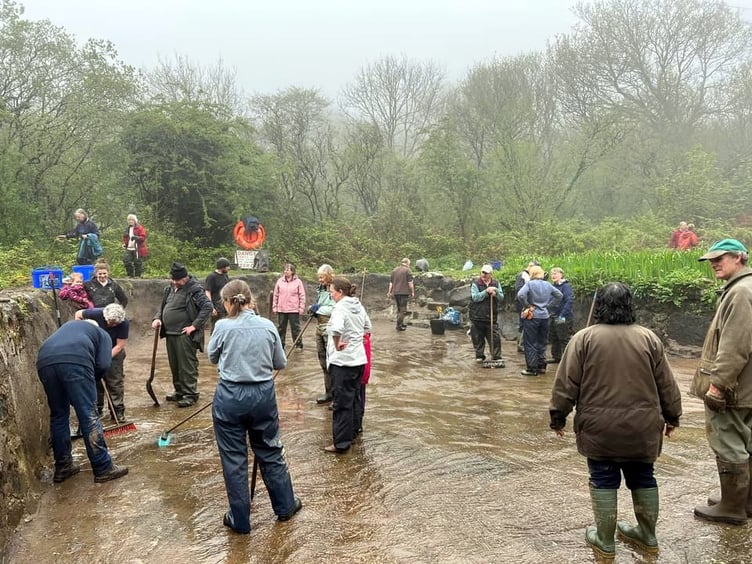 Wet weather did not deter a mini-army of villagers in Peter Tavy walking en-mass to the pond at the Coombe with an array of tools to clear the newly restored pond.