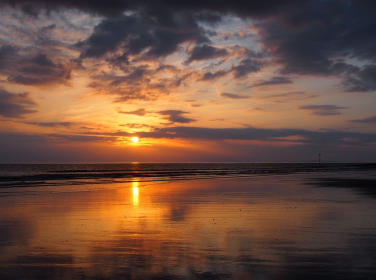 Sunset reflections at Tywyn beach, captured by Margaret Pugnet