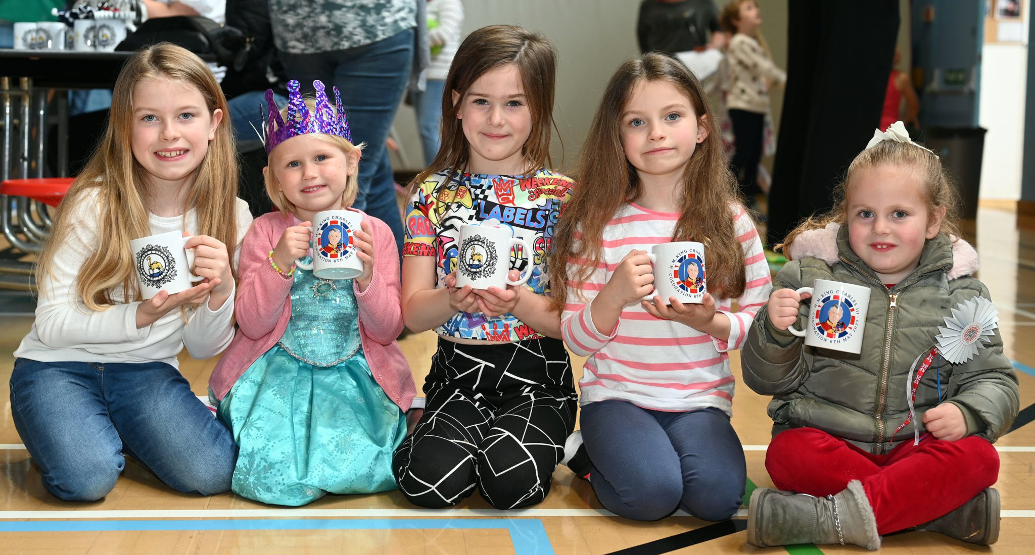 Proudly showing off their Coronation Mugs donated by Camelford Town Council are Tilly, Eva, Gracie, Bella and Emily