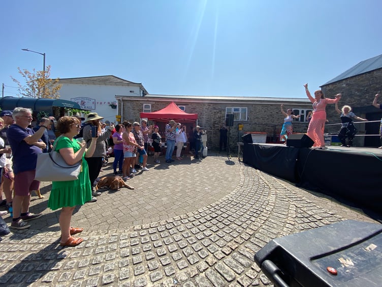Visitors watching Jilly Belly Dance on the Spar Stage