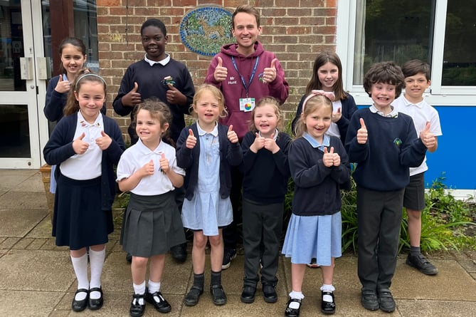 Medstead CE Primary School pupils and staff give a thumbs up to their 'good' Ofsted report, May 2023.