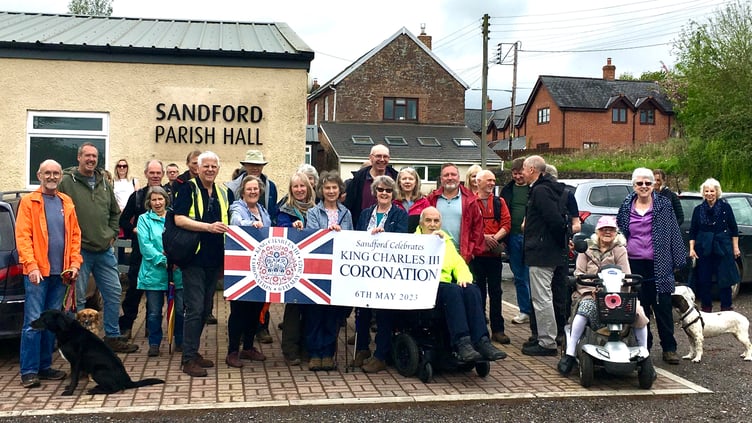 Walkers with a banner before the start at Sandford Parish Hall.