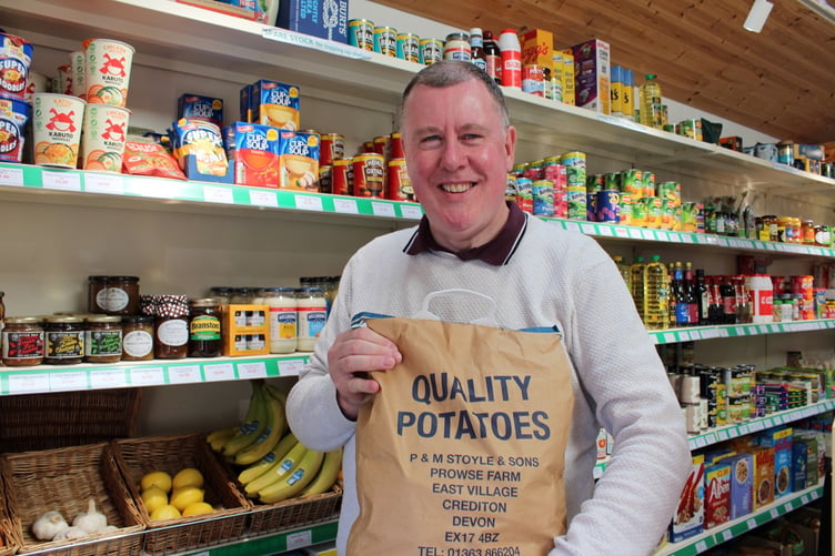 The Cheriton Fitzpaine Community shop manager with a sack of potatoes sold at the shop. SR 7777