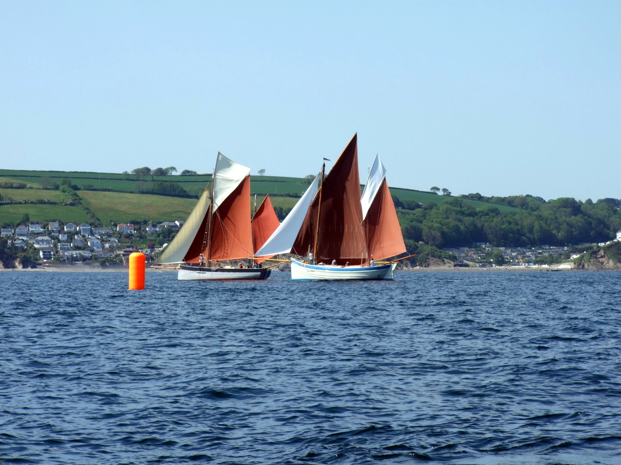 OUT IN FRONT: Jon and Judy Brickhill’s former fishing lugger Guide Me, which was built on the quayside at Looe in 1911, makes her way to the front of the fleet ahead of Nick Gates’ Ocean Pearl.