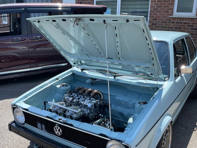 The gleaming engine of one of the cars.