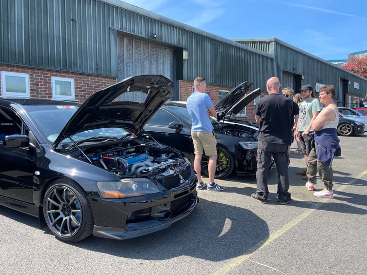 Admiring one of the cars at Builds and Brews. AQ 9537