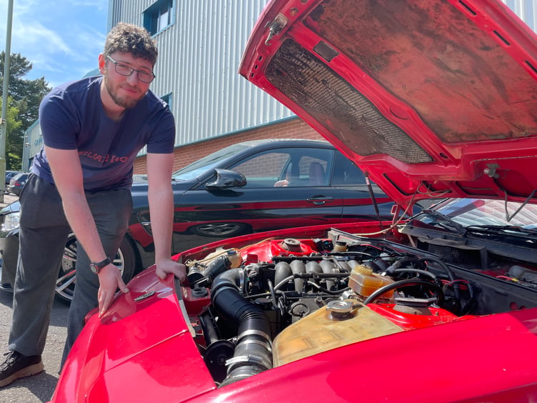 Taris Jewell of Sandford with his red 1983 Porsche in which he has a Chevrolet Corvette engine, all hand-built and machined, complete with a fine exhaust and cooling pipes. AQ 9563