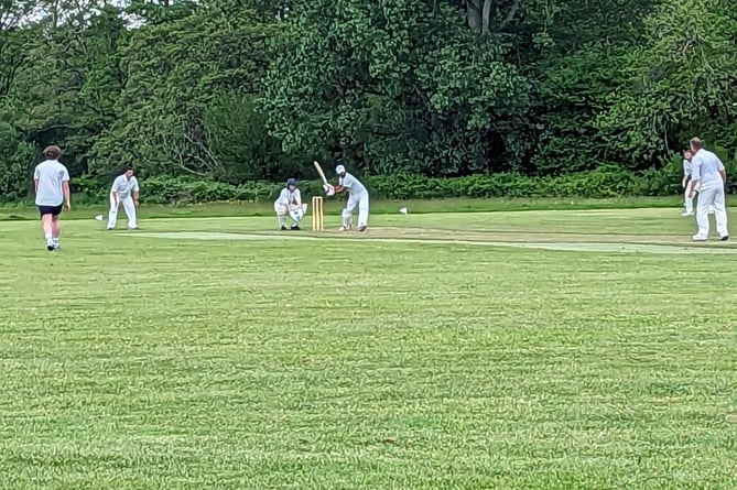 Bharat Katta hits a big six over mid-wicket to reach his century for Petersfield’s second team against Purbrook’s third team