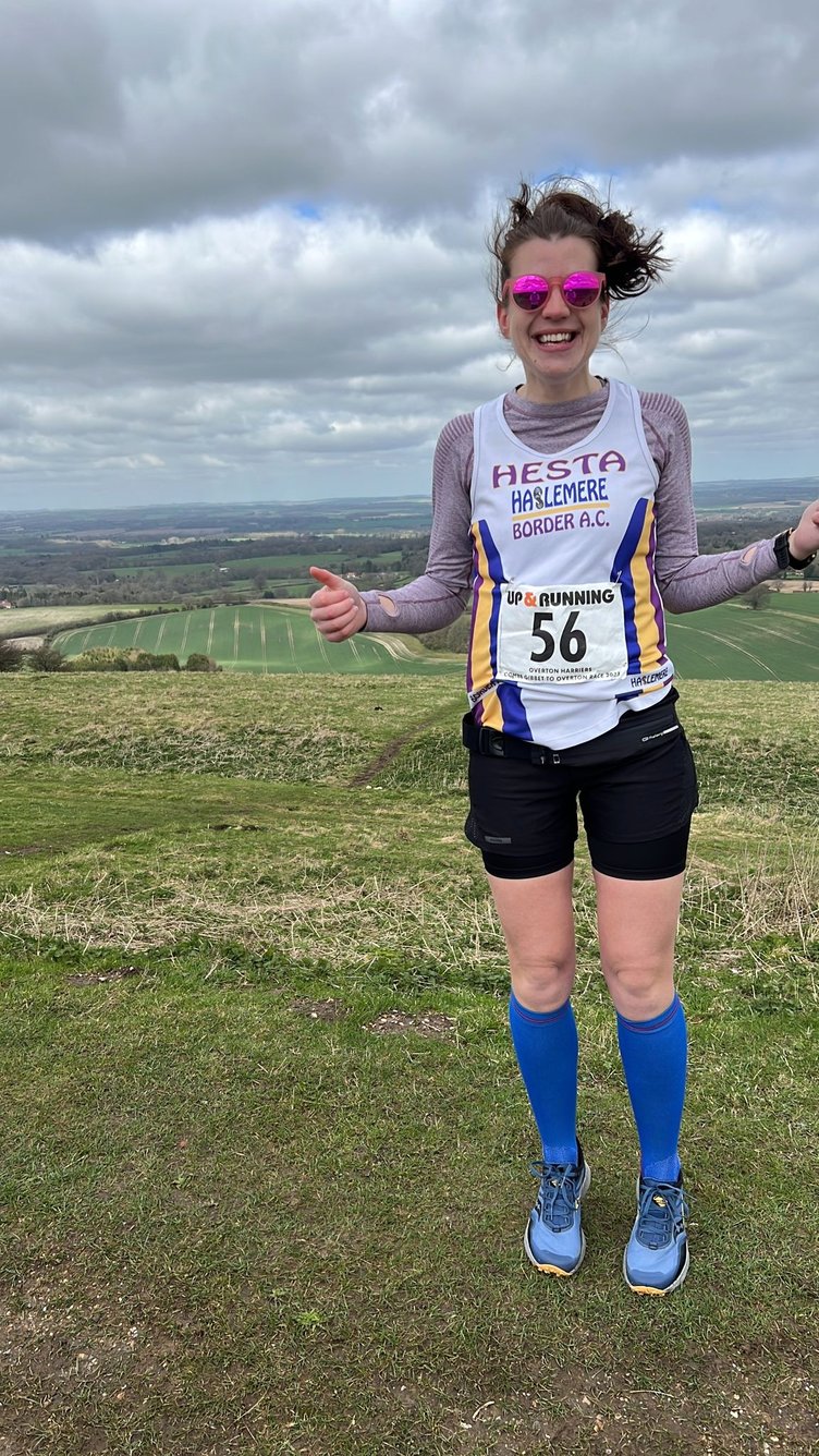 A windswept Hesta Gilham at Inkpen Beacon for the start of the Combe Gibbet to Overton trail run
