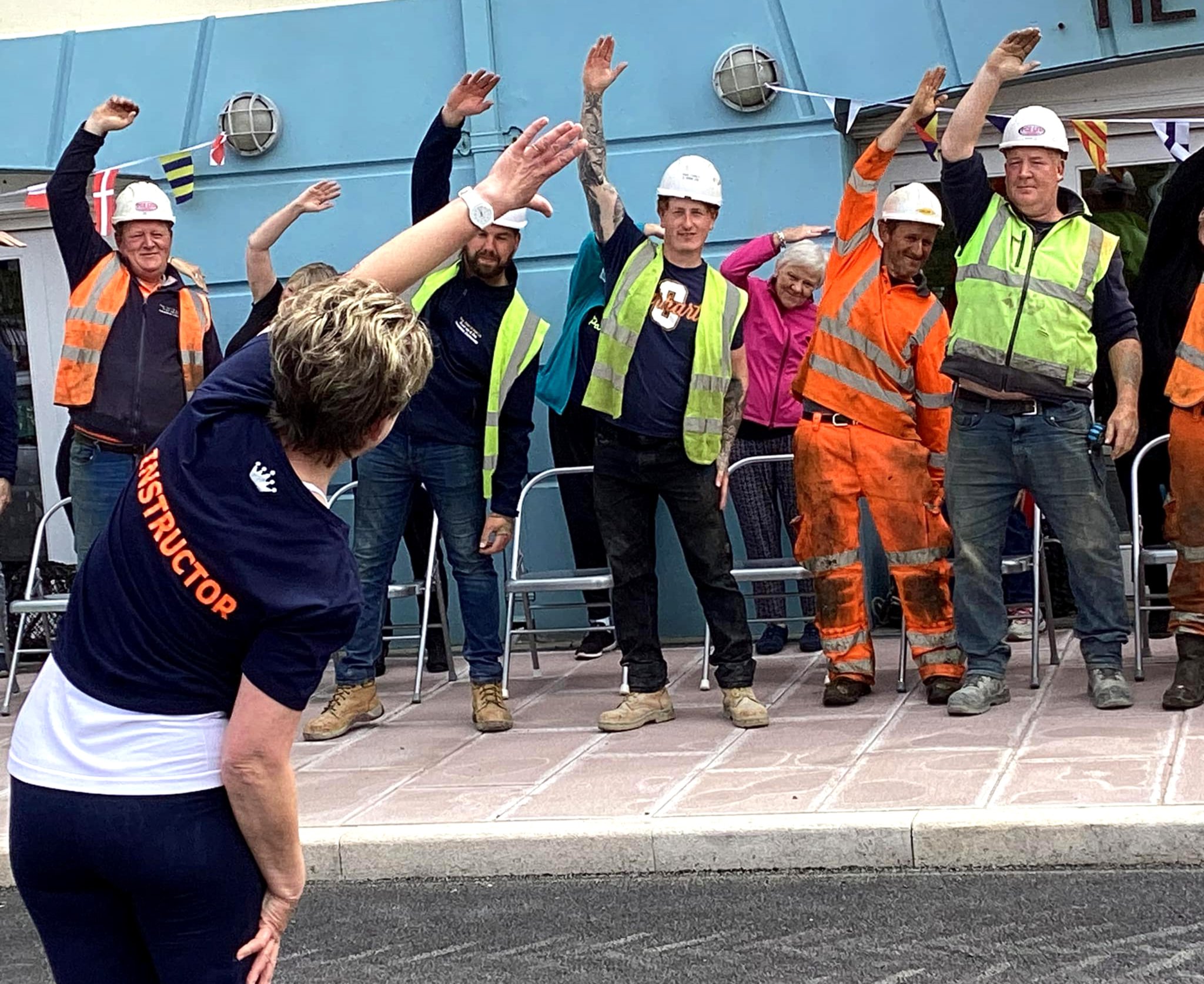 A pilates class involving contractors on Peel Quay