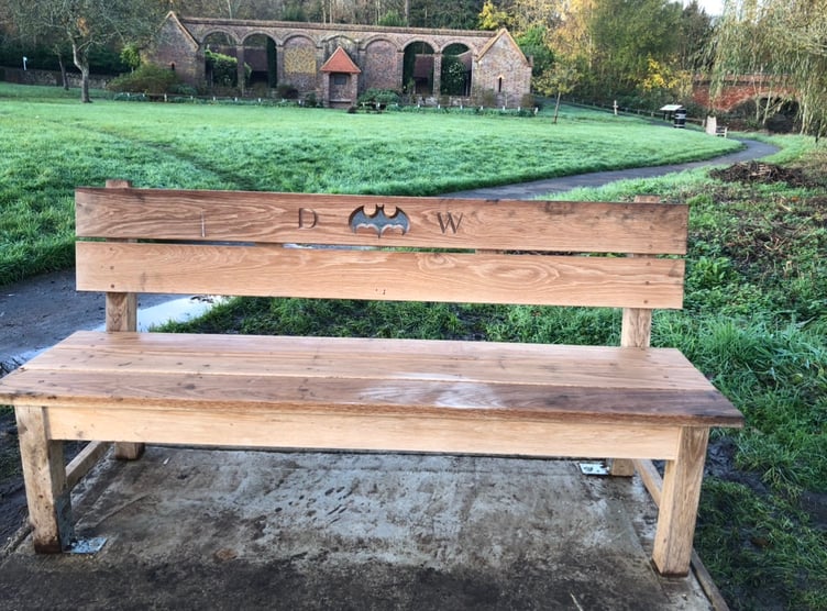 Andy Wyatt is continuing his husband Daron Wyatt's legacy with a bench in Godalming with the Batman symbol engraved on the back