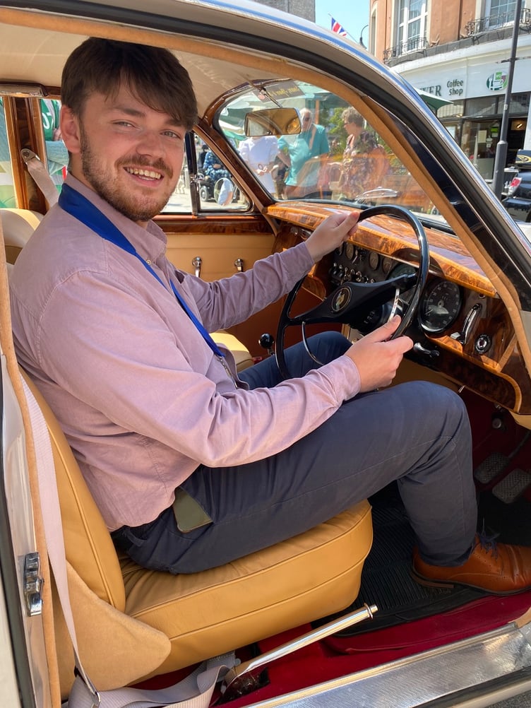 Cllr Alex Hall at the wheel of a Mk II Jaguar that caught his eye at the Newton Abbot classic vehicle show.Picture: NATC (28-5-23)