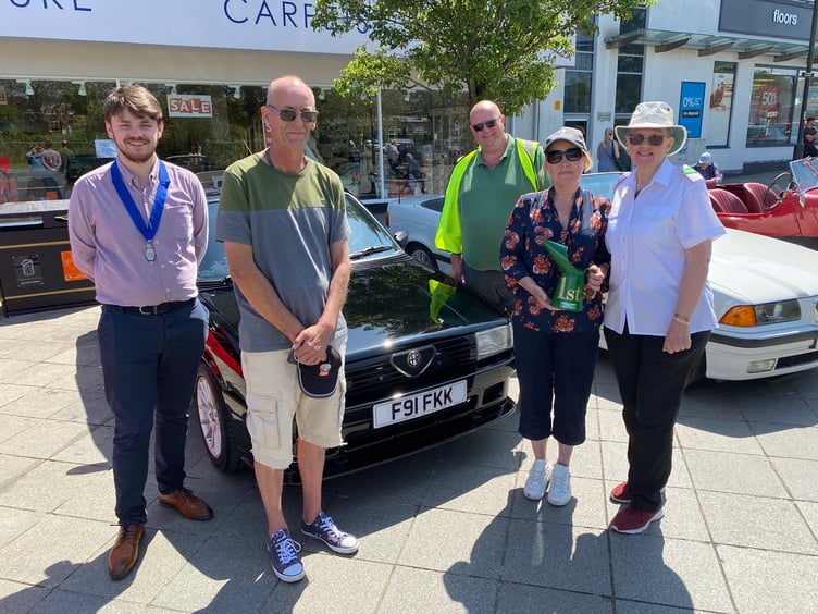 Left - right Cllr Alex Hall, Don Crompton, Jamie Theobold, Lisa DientÕe and Jackie Morris with the winning Alfa Romeo. at the Newton Abbot classic vehicle show.Picture: NATC (28-5-23)