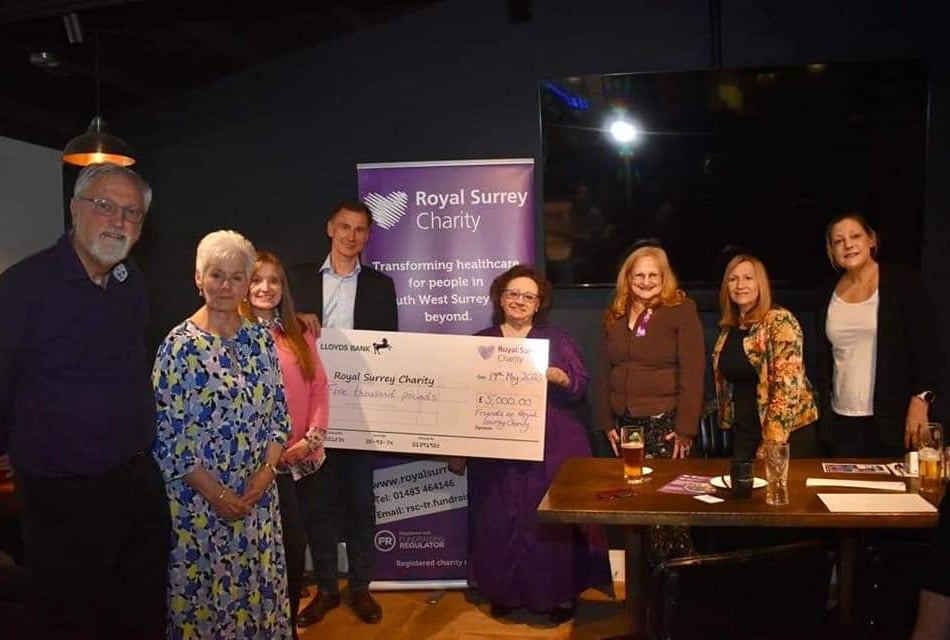 <p>Judith Storey of the Friends of Royal Surrey hands over the cheque to MP Jeremy Hunt for the Royal Surrey cancer and surgical innovation centre campaign</p>