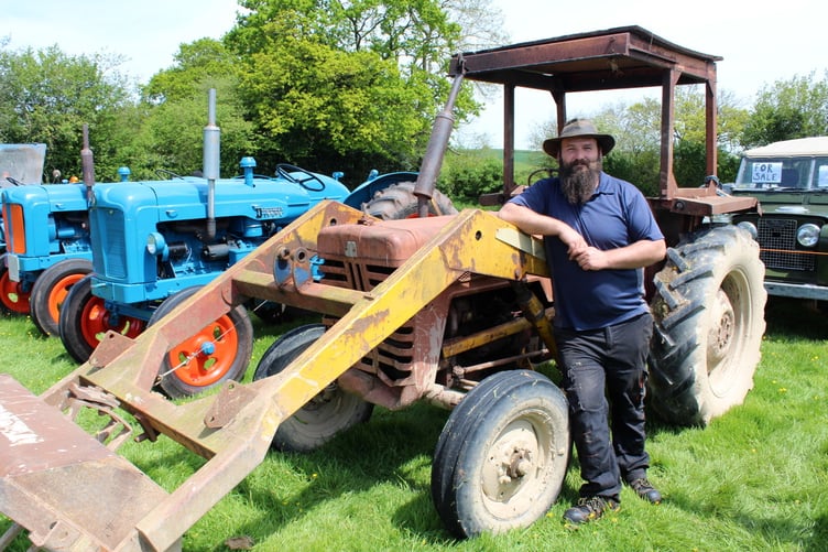 Adam Boult with his 1976 International front loader which works on a farm near Newton St Cyres. SR 7864